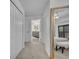 Hallway with a view into a bathroom with gray vanity and mirror, next to a bedroom at 6970 Piazza St, Orlando, FL 32819
