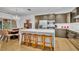 Modern kitchen with stainless steel appliances, large island, and dining area at 6970 Piazza St, Orlando, FL 32819