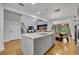 Open kitchen featuring a large island, dining area, and views to the living room at 6970 Piazza St, Orlando, FL 32819