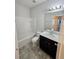 Bathroom with tub-shower combo, single sink vanity with cabinet, toilet, and tile flooring at 7673 Ripplepointe Way, Windermere, FL 34786
