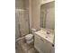 Bathroom with a shower, toilet, mirror, and vanity with sink and white cabinets at 7673 Ripplepointe Way, Windermere, FL 34786