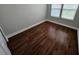 Bedroom with hardwood flooring and two windows with blinds at 7673 Ripplepointe Way, Windermere, FL 34786