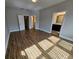Bedroom with hardwood flooring and views of a bathroom and closet at 7673 Ripplepointe Way, Windermere, FL 34786