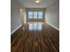 Bedroom with hardwood flooring and three windows at 7673 Ripplepointe Way, Windermere, FL 34786