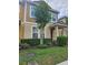 Inviting two-story townhome with a well-maintained lawn and mature tree providing shade and curb appeal at 7673 Ripplepointe Way, Windermere, FL 34786