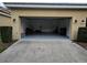 Open two car garage with ample space for parking, storage, and natural light at 7673 Ripplepointe Way, Windermere, FL 34786