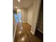 Hallway with hardwood flooring, closet with shelving, and washer and dryer in the distance at 7673 Ripplepointe Way, Windermere, FL 34786