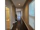 Bright hallway with wood floors and access to a bathroom, stairs and back patio doors at 7673 Ripplepointe Way, Windermere, FL 34786