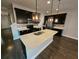Modern kitchen features a large center island, stainless steel appliances, and stylish dark cabinetry at 7673 Ripplepointe Way, Windermere, FL 34786