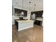 Bright kitchen with hardwood floors, center island, stainless steel appliances and mosaic tile backsplash at 7673 Ripplepointe Way, Windermere, FL 34786