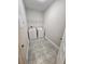 Laundry room with tile flooring, washer and dryer, and wire shelving at 7673 Ripplepointe Way, Windermere, FL 34786