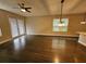 Spacious living area with hardwood floors, French doors, and a ceiling fan at 7673 Ripplepointe Way, Windermere, FL 34786