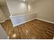 Loft with light-colored walls, wood flooring and railing at 7673 Ripplepointe Way, Windermere, FL 34786