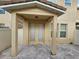 Outdoor patio with brick pavers, stucco columns, and an access door at 7673 Ripplepointe Way, Windermere, FL 34786