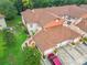 Aerial view of condos featuring tile roofs, lush greenery, and manicured lawns create an inviting community at 7865 Sugar View Ct # 7865, Orlando, FL 32819