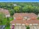 Aerial view of condos featuring tile roofs, lush greenery, and manicured lawns create an inviting community at 7865 Sugar View Ct # 7865, Orlando, FL 32819