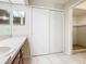 Bathroom featuring a closet, shower with mosaic accents, and spacious vanity at 7865 Sugar View Ct # 7865, Orlando, FL 32819