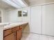Bathroom featuring a large closet, spacious vanity, and mirror, illuminated by overhead lighting at 7865 Sugar View Ct # 7865, Orlando, FL 32819