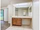 Bathroom featuring a vanity with cabinets, a mirror, and open access to a doorway at 7865 Sugar View Ct # 7865, Orlando, FL 32819