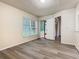 A bright bedroom with new wood-look flooring and a sliding glass door to the lanai at 7865 Sugar View Ct # 7865, Orlando, FL 32819