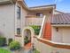 Inviting two-story condo with a stucco exterior, terracotta tile roof, and a cozy entrance with an arched opening at 7865 Sugar View Ct # 7865, Orlando, FL 32819