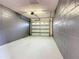 Spacious one-car garage with block walls and a white door at 7865 Sugar View Ct # 7865, Orlando, FL 32819