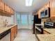 Bright kitchen featuring stainless steel appliances, wood cabinets, granite counters, and a sunny breakfast nook at 7865 Sugar View Ct # 7865, Orlando, FL 32819