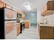Spacious kitchen with wood cabinets, granite countertops, stainless steel appliances, and light-colored flooring at 7865 Sugar View Ct # 7865, Orlando, FL 32819