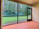 Screened lanai with a view of the fenced backyard and lush landscaping at 7865 Sugar View Ct # 7865, Orlando, FL 32819