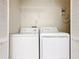 Laundry room features a washer, dryer, and wire shelving for storage at 7865 Sugar View Ct # 7865, Orlando, FL 32819