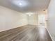 Spacious living room featuring open layout and modern flooring with access to kitchen area at 7865 Sugar View Ct # 7865, Orlando, FL 32819