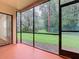 Enclosed patio with screen and view of the community lawn, ready for relaxation at 7865 Sugar View Ct # 7865, Orlando, FL 32819