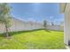 Large backyard featuring green grass and a tall vinyl privacy fence, perfect for outdoor activities at 824 Ofanto Way, Haines City, FL 33844