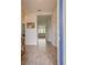 Foyer features tile floors, an ocean themed art piece, and a view into the living room at 824 Ofanto Way, Haines City, FL 33844