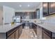 Modern kitchen features sleek cabinets, stainless steel appliances, tile flooring, and quartz countertops at 824 Ofanto Way, Haines City, FL 33844
