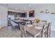 A kitchen with stainless steel appliances, a central island, a dining table and wood-look tile at 824 Ofanto Way, Haines City, FL 33844