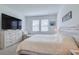 Inviting main bedroom featuring a large bed, soft carpet, a dresser, and a cozy seating area at 824 Ofanto Way, Haines City, FL 33844