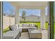 Covered patio with comfortable outdoor seating, ideal for relaxing and enjoying the backyard view at 824 Ofanto Way, Haines City, FL 33844