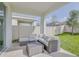 Inviting patio with plush seating, offering a cozy spot for outdoor entertaining and leisure at 824 Ofanto Way, Haines City, FL 33844