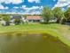 Aerial view of the backyard, highlighting a serene pond and well-kept outdoor space at 8322 Cascade Oaks Dr, Orlando, FL 32822