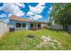 View of backyard, featuring a covered patio, and lawn area at 8322 Cascade Oaks Dr, Orlando, FL 32822