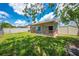 Backyard showcasing a covered patio area, lawn, and partial fencing; perfect for outdoor relaxation at 8322 Cascade Oaks Dr, Orlando, FL 32822