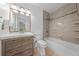 Bathroom featuring neutral tile, modern vanity, and shower-tub combo with tiled surround at 8322 Cascade Oaks Dr, Orlando, FL 32822