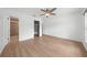 The sunlit bedroom boasts wood-look floors and access to a walk-in closet and en suite bathroom at 8322 Cascade Oaks Dr, Orlando, FL 32822