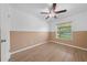 Bedroom featuring wood-look flooring, fan, and neutral two-tone color scheme at 8322 Cascade Oaks Dr, Orlando, FL 32822