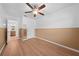 Bedroom featuring laminate floors, ceiling fan, and access to an en-suite bathroom at 8322 Cascade Oaks Dr, Orlando, FL 32822