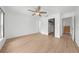 Spacious bedroom features a ceiling fan, wood-look floors, and closet access at 8322 Cascade Oaks Dr, Orlando, FL 32822
