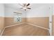 Bedroom with laminate floors, ceiling fan, and neutral two-tone color scheme at 8322 Cascade Oaks Dr, Orlando, FL 32822