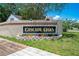 Entrance sign for Cascade Oaks community with well-maintained landscaping at 8322 Cascade Oaks Dr, Orlando, FL 32822