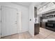 Inviting foyer featuring tile floors, a front door with window, and a view of the updated kitchen at 8322 Cascade Oaks Dr, Orlando, FL 32822